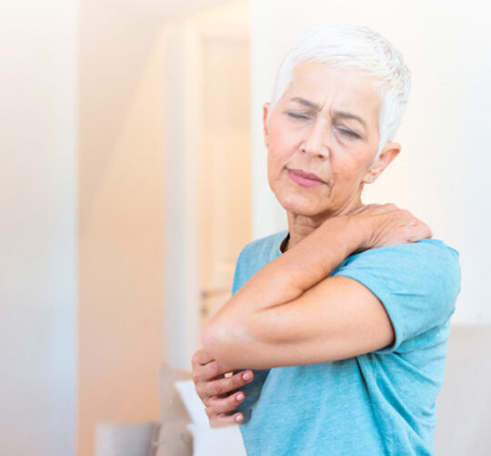 mujer de la tercera edad con gesto de dolor en la espalda